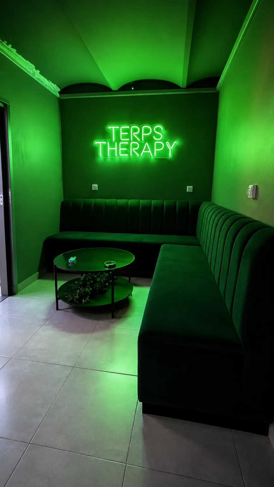 Green lounge at Terps Therapy Barcelona with neon sign and velvet sofas