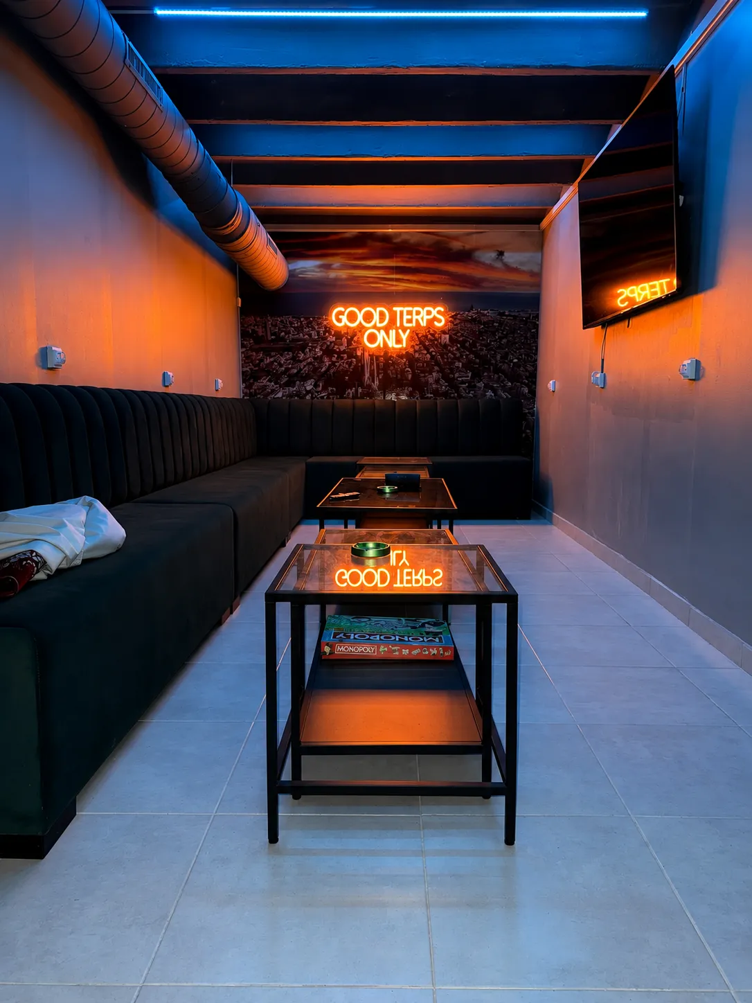 Sala de Juegos games room at Terps Therapy lit in orange neon